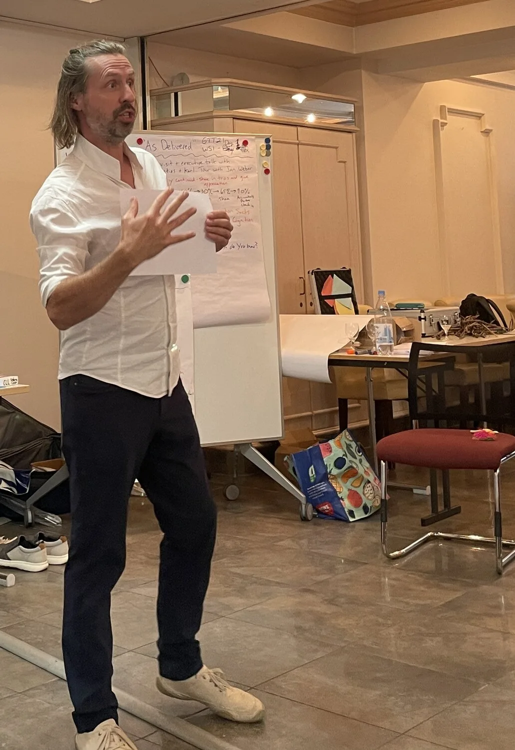 Matthias Orgler facilitating a workshop beside a flipchart
